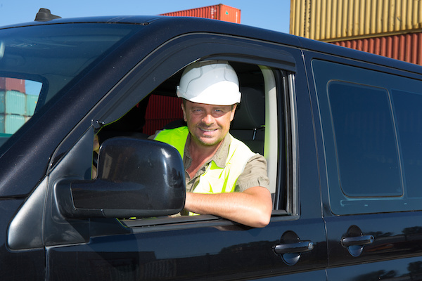 Engineer builder at construction site driver In Van