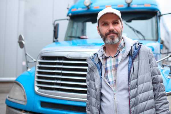 Mature bearded man against retro styled truck